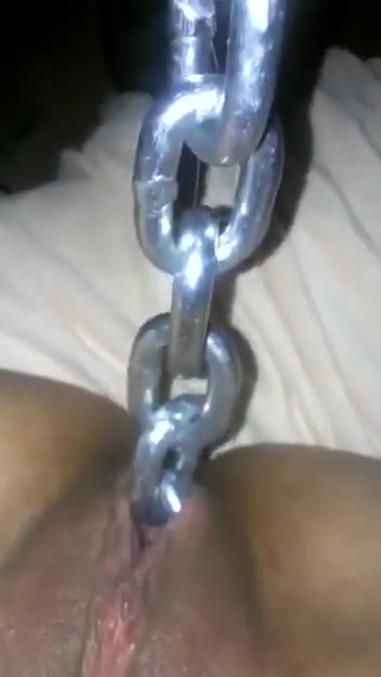 Woman pulls long chain out of her pussy